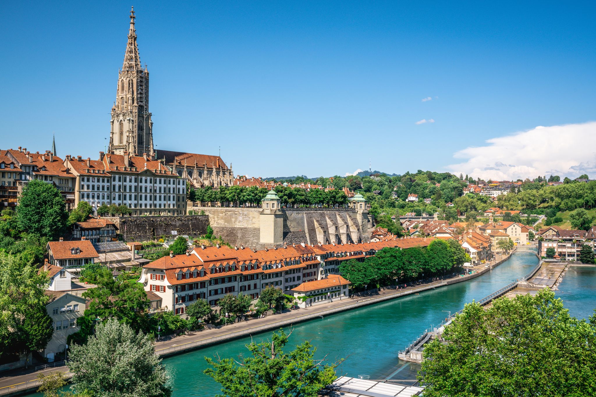 photo of aerial view of scenic Bern old town cityscape with old buildings Bern Minster cathedral tower and Aare River view in Bern Switzerland
