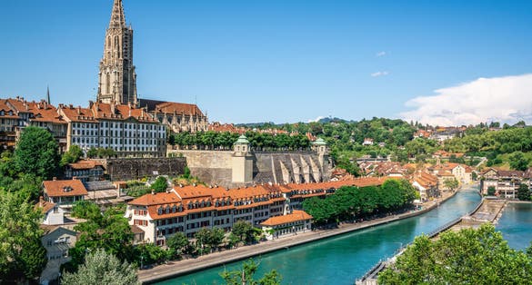 photo of aerial view of scenic Bern old town cityscape with old buildings Bern Minster cathedral tower and Aare River view in Bern Switzerland