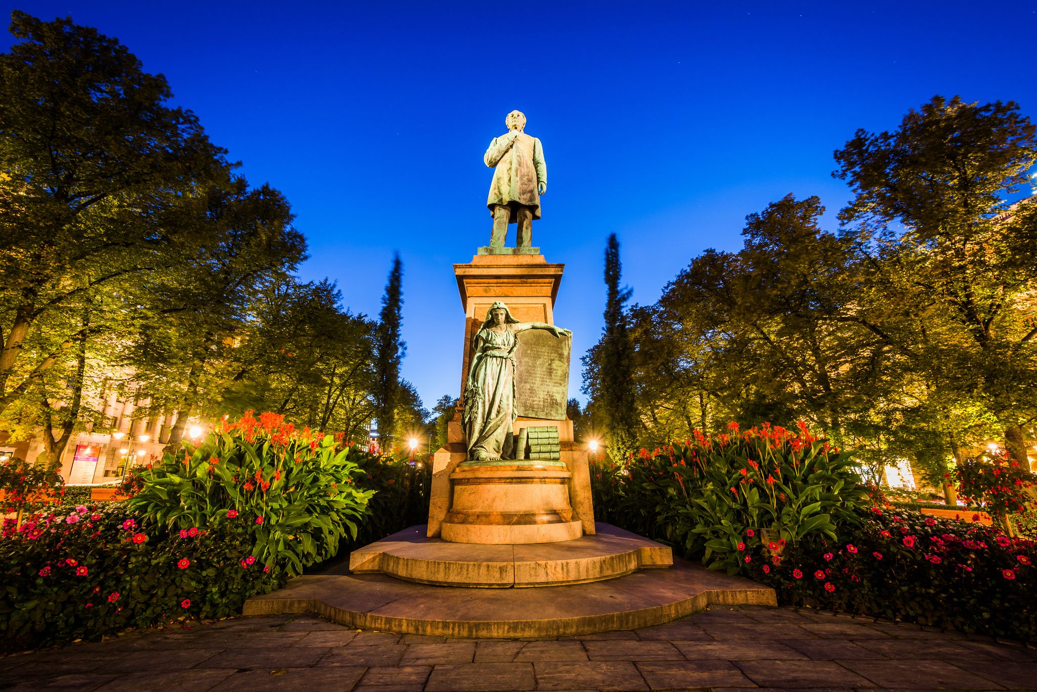 Photo of Statue of Johan Ludwig Runeberg at Esplanadi Park at night, in Helsinki, Finland.