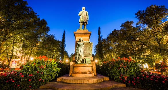 Photo of Statue of Johan Ludwig Runeberg at Esplanadi Park at night, in Helsinki, Finland.
