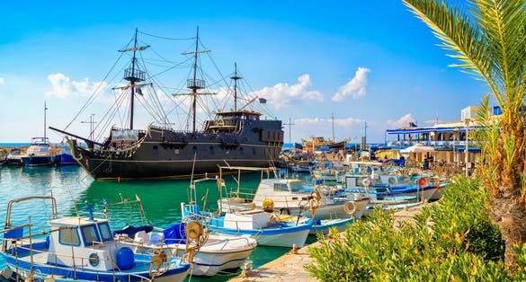 Pirate ship and fishing boats in harbor of Ayia Napa, Cyprus. Ayia Napa seaside of Mediterranean Sea, Cyprus. Famous places and travel destination of Ayia Napa, Cyprus. Republic of Cyprus