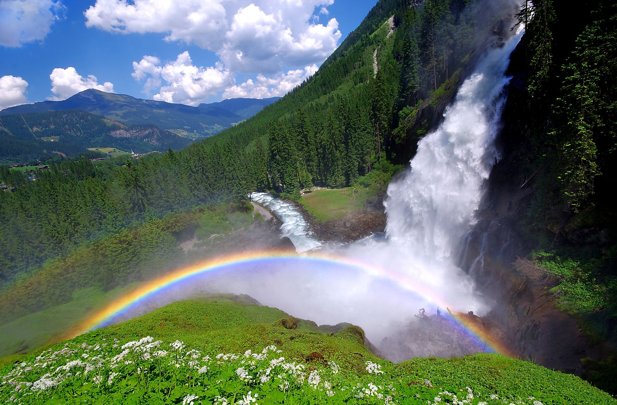 Photo of beautiful rainbow in Krimml Waterfalls and the surroundings forest in Krimml, Austria.