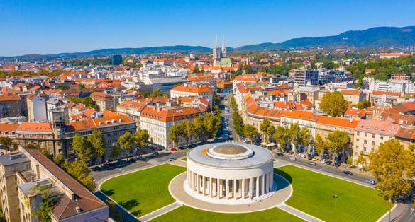 Aerial drone view of Mestrovic pavilion, monumental art gallery and cathedral in city centre on sunny summer day, Zagreb, Croatia