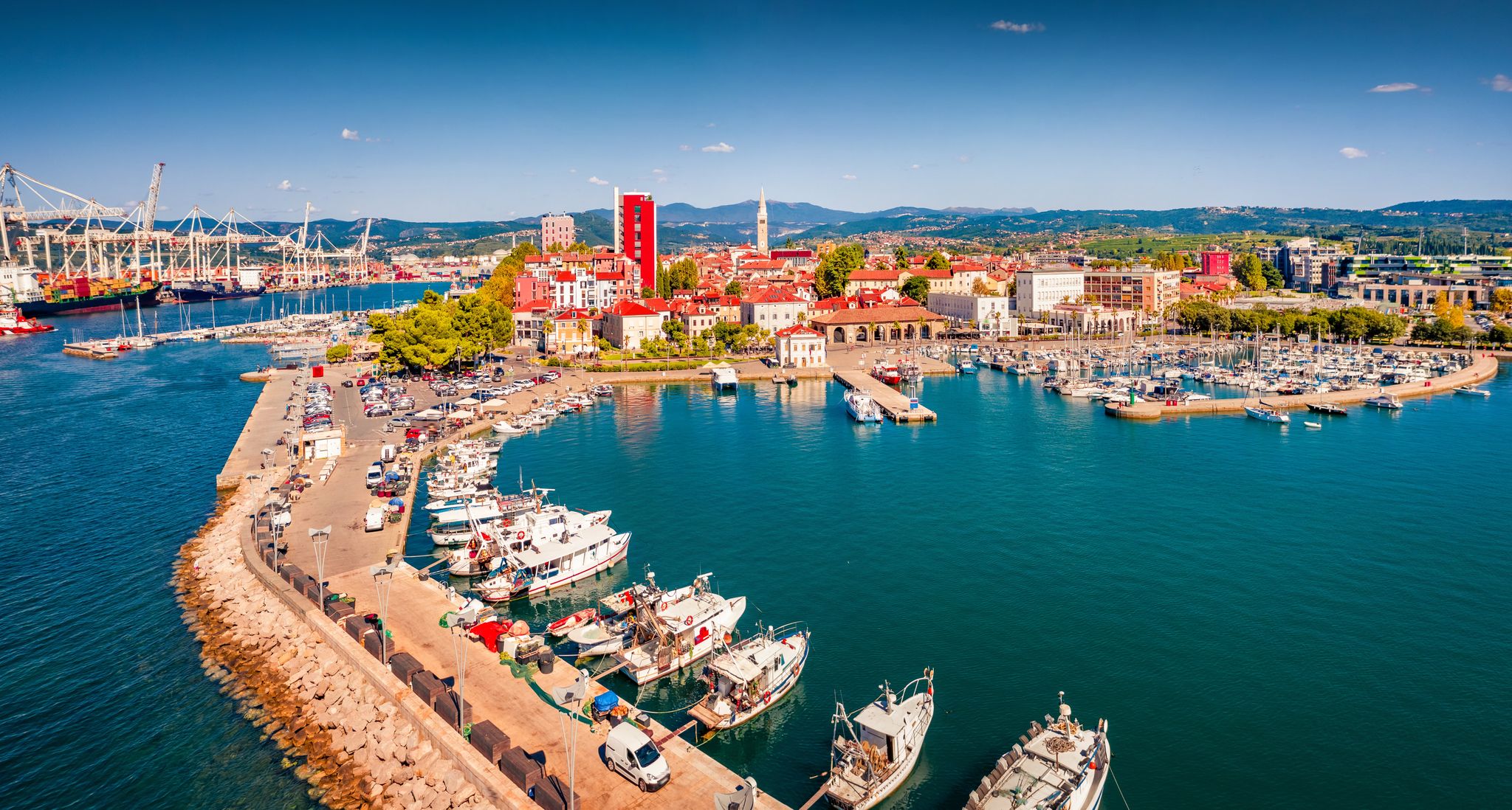 Adorable view from flying drone of Koper port. Colorful summer scene of Adriatic coastline, Slovenia, Europe. Picturesque Mediterranean seascape. Traveling concept background.