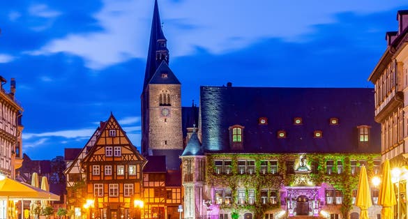 photo of view of Quedlinburg Castle over old town at sunset, Germany