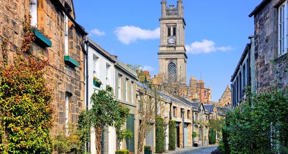 photo of view of Quaint old residential street with church spire in Edinburgh Scotland during springtime