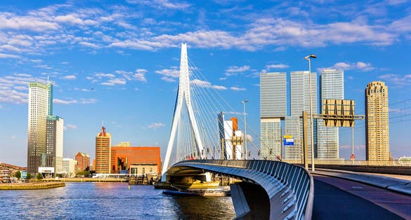 Photo of attractive view of Renowned Erasmusbrug (Swan Bridge) in Rotterdam in front of Port and Harbour.
