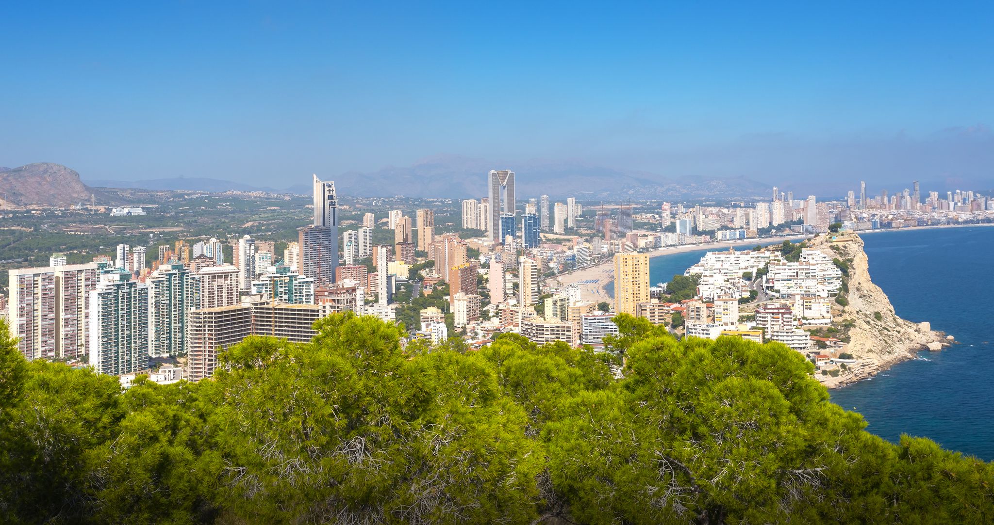 photo of panorama of the towns and Tossal de la Cala from a hill in a natural park in Benidorm, Valencia, Spain.