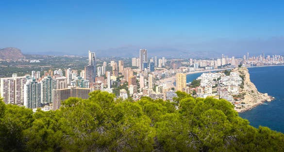 photo of panorama of the towns and Tossal de la Cala from a hill in a natural park in Benidorm, Valencia, Spain.