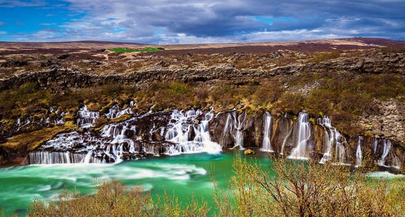 photo of Hraunfossar, a series of waterfalls pouring into Hvita River, Borgarfjordur, Western Iceland,