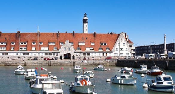 Calais lighthouse and port wharf in the north of France