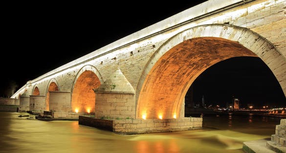 Photo of famous Stone bridge at night in Skopje, Macedonia.