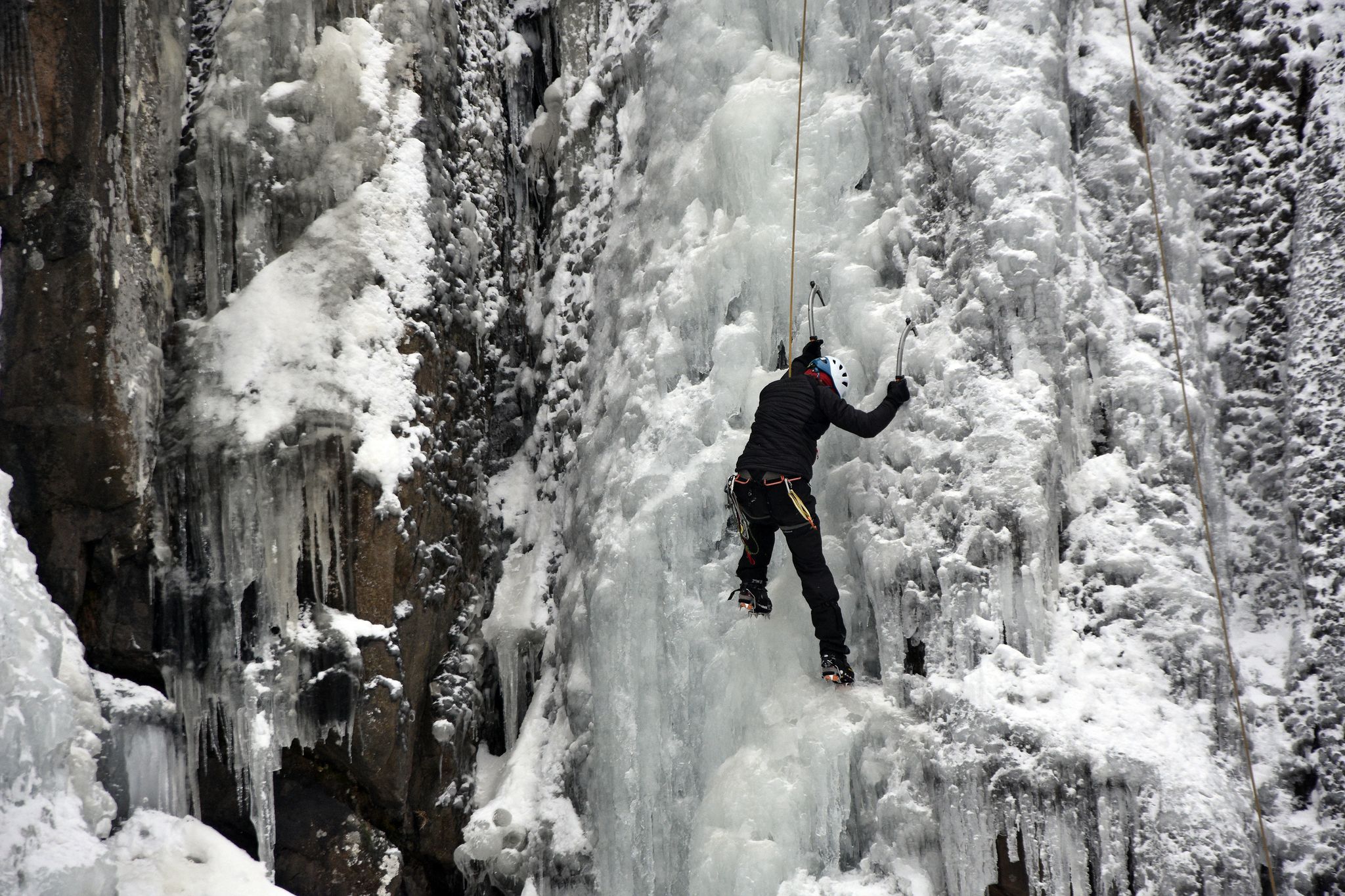 photo of view of Ice climber climbing on the frozen Boyana Waterfall in Vitosha Mountain near Sofia City, Bulgaria,Sofia bulgaria.