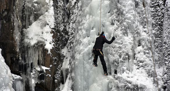 photo of view of Ice climber climbing on the frozen Boyana Waterfall in Vitosha Mountain near Sofia City, Bulgaria,Sofia bulgaria.