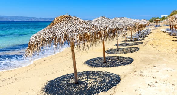 Photo of parasols on Agia Anna beach, one of the best organized beaches of Naxos. Cyclades Islands, Greece.