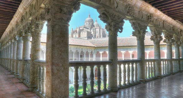 Photo of cloister of the convent of the owners with the cathedral in the background in Salamanca, Spain.