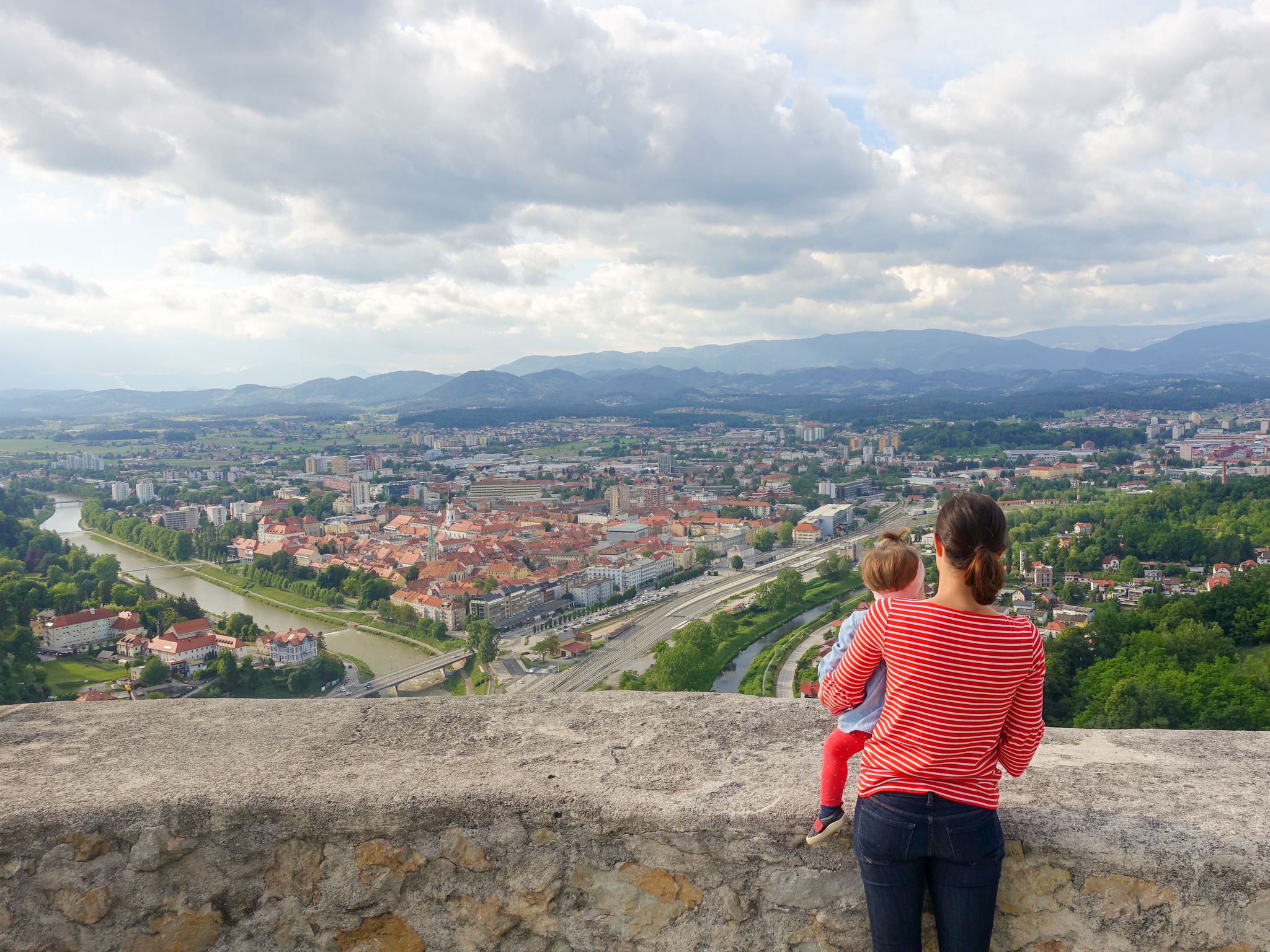 Woman and a child on the Celje Old castle (Celjski Stari grad) looking at the amazing view of town Celje in Lasko valley in Julian Alps mountains, Slovenia, Styria