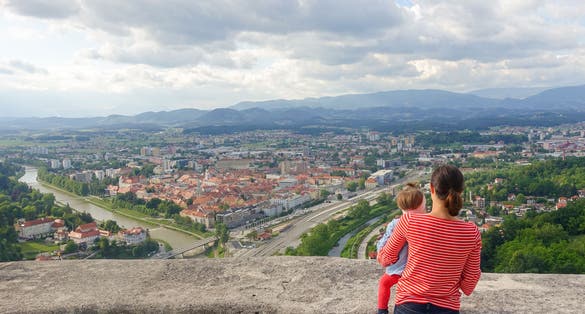 Woman and a child on the Celje Old castle (Celjski Stari grad) looking at the amazing view of town Celje in Lasko valley in Julian Alps mountains, Slovenia, Styria