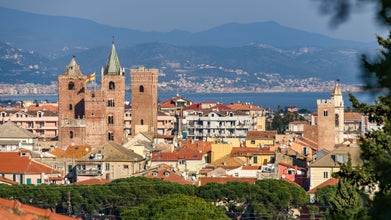 Photo of The medieval towers in the cityscape of the ligurian village of Albenga, situated on the italian Riviera.
