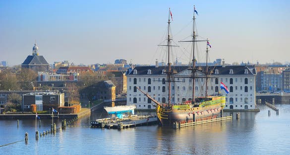 photo of skyline of Amsterdam with National Maritime Museum on the foreground. Netherlands.