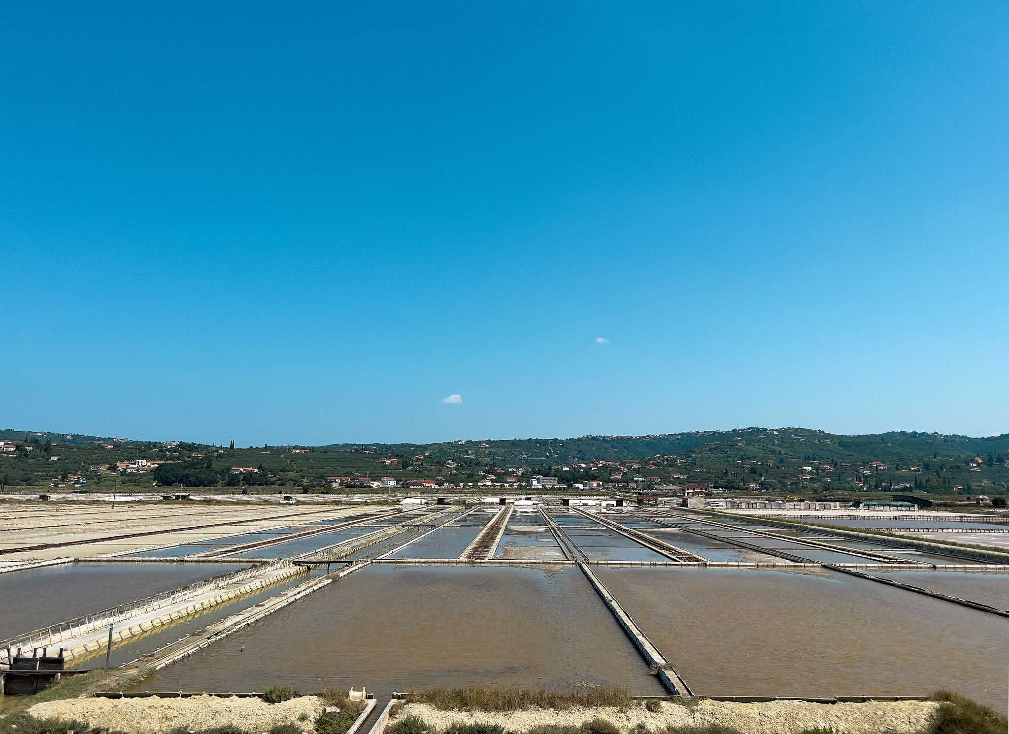 Photo of Saltworks in Strunjan, Piran, on the Slovenian Istrian coast. traditional oldest salt extraction area, salt basin, salt mining.