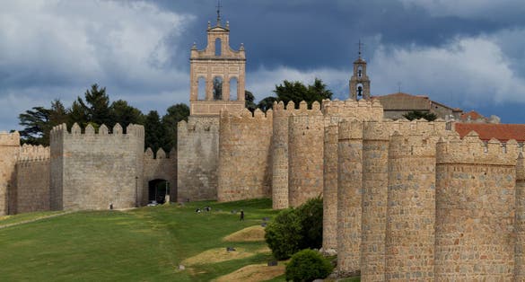 photo of view of Avila Medieval Walls with Puerta del Carmen Gate and Bell Gable - Avila, Spain.