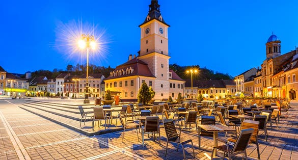 Brasov, Transylvania, Romania. Twilight scenery with Main Square and Council House in medieval center of Brasov, Black Church illuminated