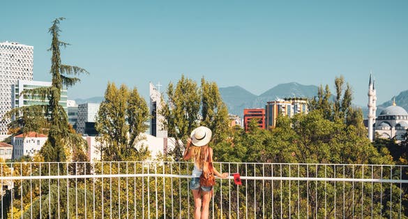 Traveler woman enjoying panoramic view of Tirana city- travel, tour tourism, vacation in Albania