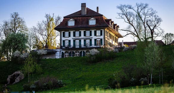 photo of old house in morning light in Elfenaupark in Bern, Switzerland.