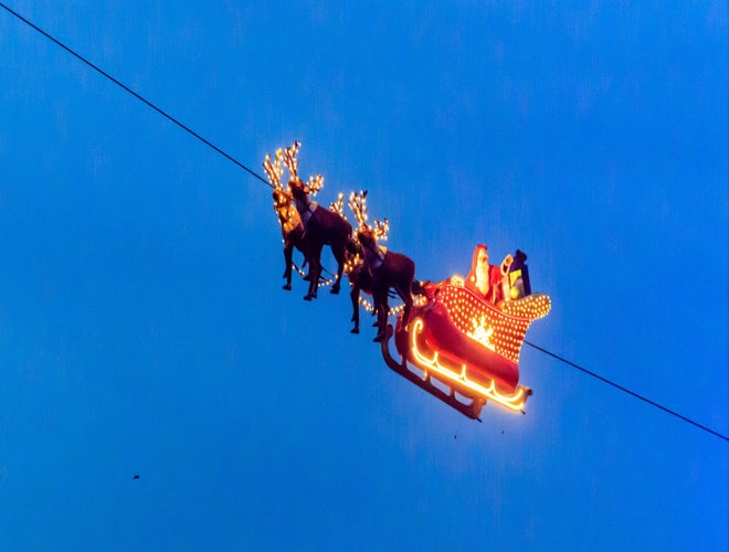 Illuminated Santa sleigh and reindeer display suspended in the sky at Montreux Noel..jpg