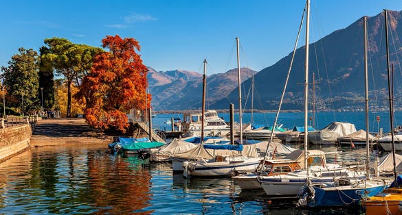 Photo of boats and yachts on Lake Maggiore in autumn in Locarno, Switzerland.