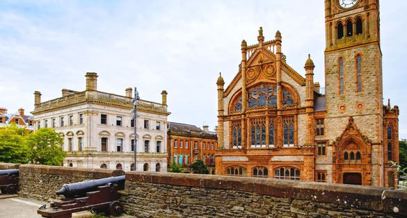 photo of view of Derry, North Ireland. Aerial view of Derry Londonderry city center in Northern Ireland, UK. Sunny day with cloudy sky, city walls and historical buildings.