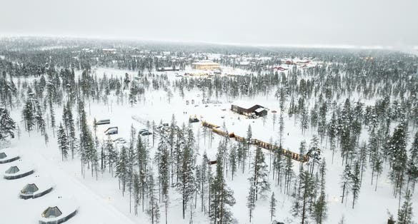 photo of Saarisalkae, Finland in beautiful white snow covered, Northern lights village hotel cabins in Northern Europe where people come to visit northern lights.