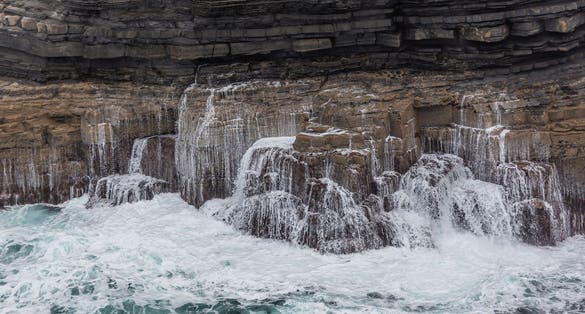 photo of Waves breaking on the cliffs - Downpatrick Head, Country Mayo, Ireland .