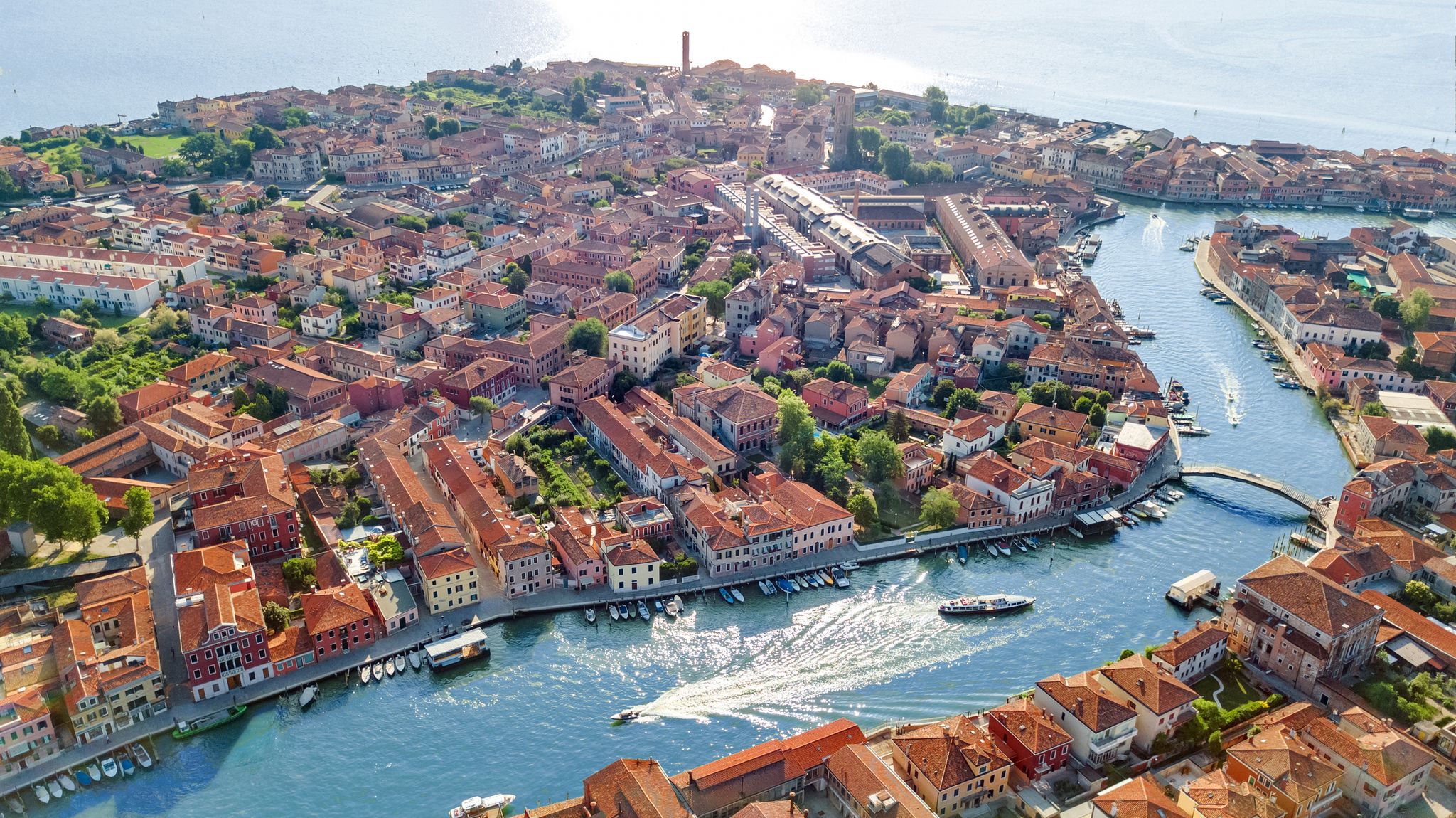 photo of view ofAerial view of Murano island in Venetian lagoon sea from above, Italy.