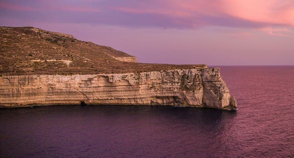 Purple skies saturate the scene in Ras id-Dawwara, Malta.