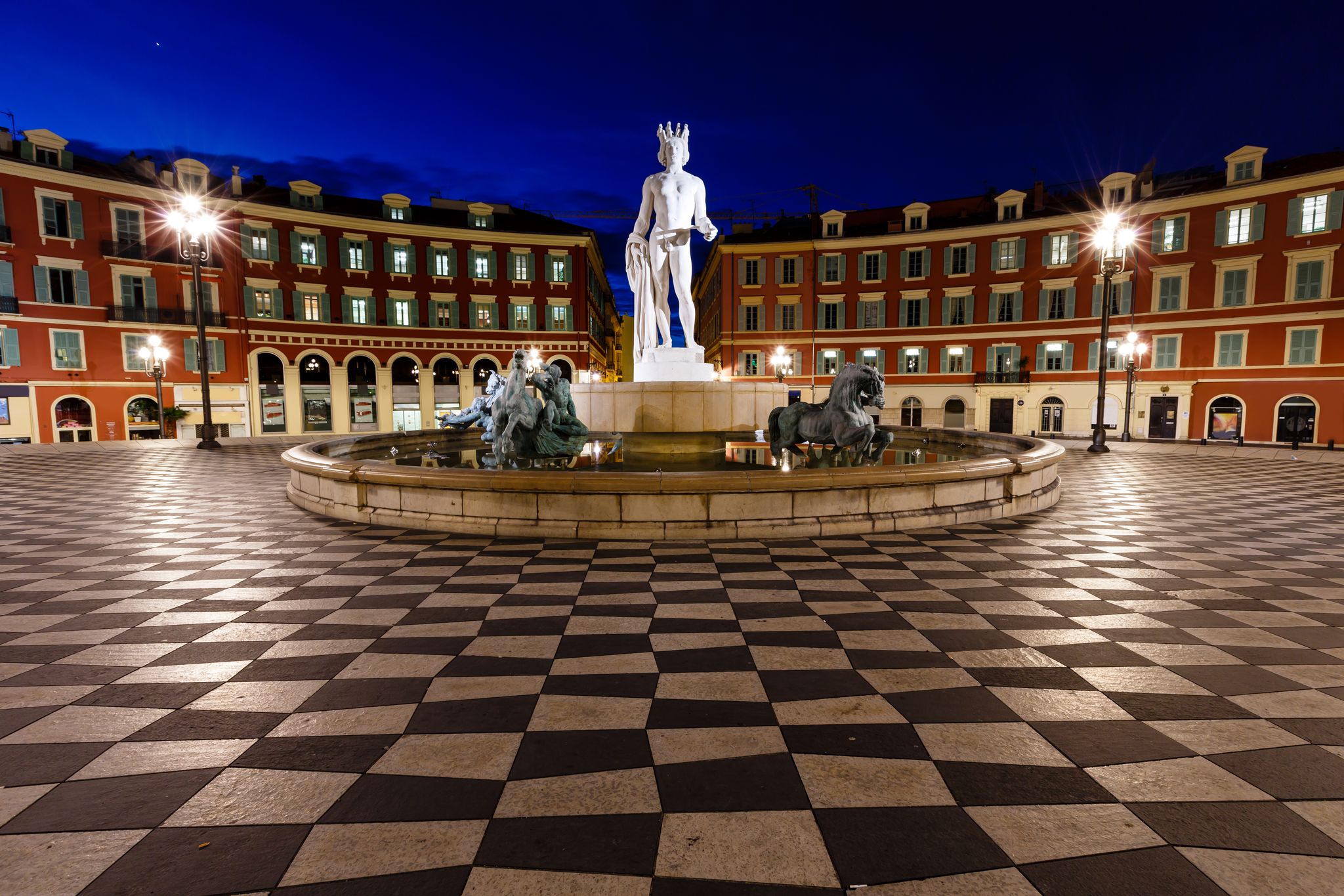 photo of The Fontaine du Soleil on Place Massena in the night in Nice, French Riviera, France.