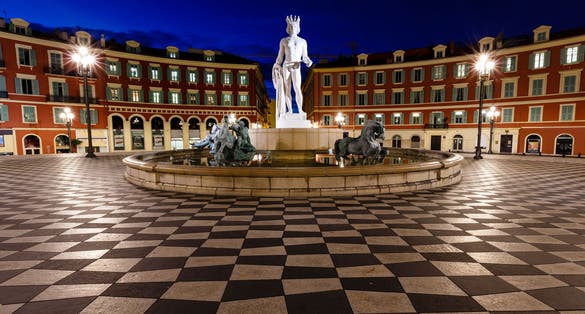 photo of The Fontaine du Soleil on Place Massena in the night in Nice, French Riviera, France.