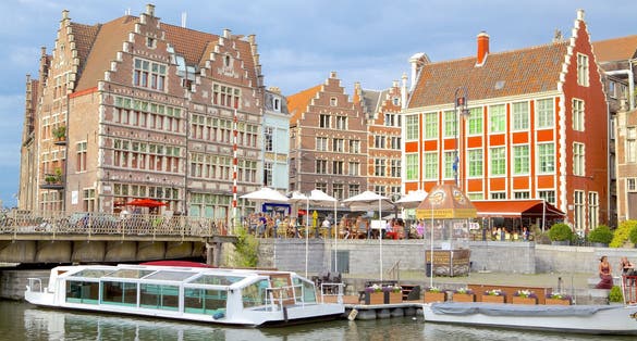 Photo of Grasbrug (bridge) across Leie River, Tourists going from one shopping district to another across small bridge in Ghent city centre, Belgium.