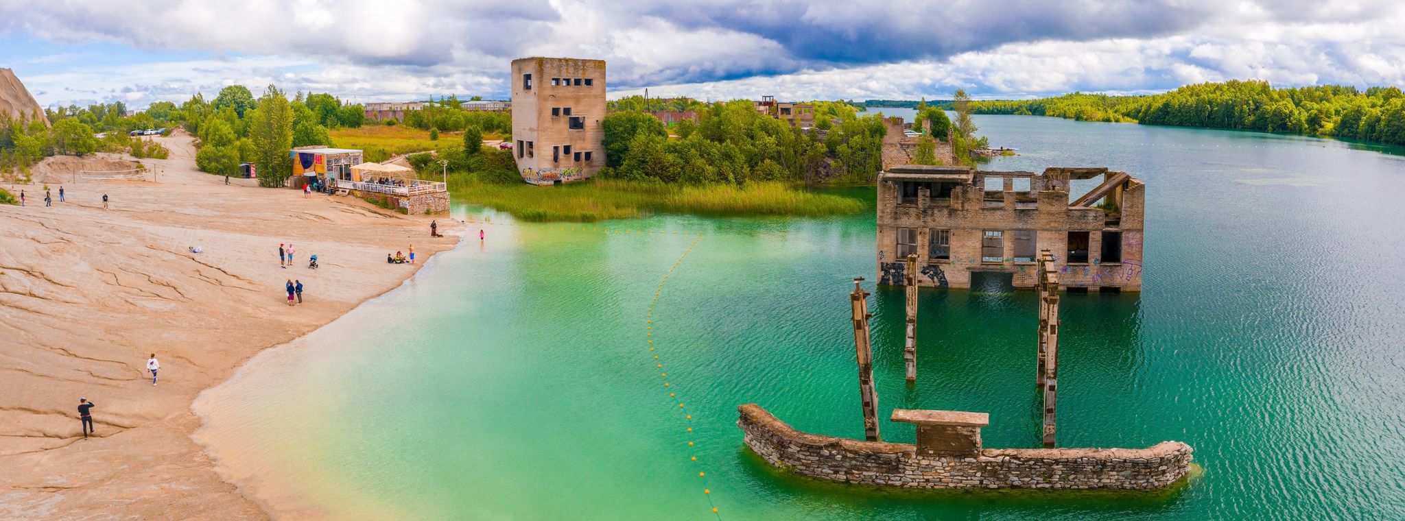 Photo of aerial view of the Rummu abandoned prison Tallinn Estonia lake beach, beautiful view of the forest, lake and old prison remains most of which are under water.