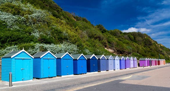 Photo of colourful wooden beach huts at Bournemouth on the South Coast of England UK Europe.
