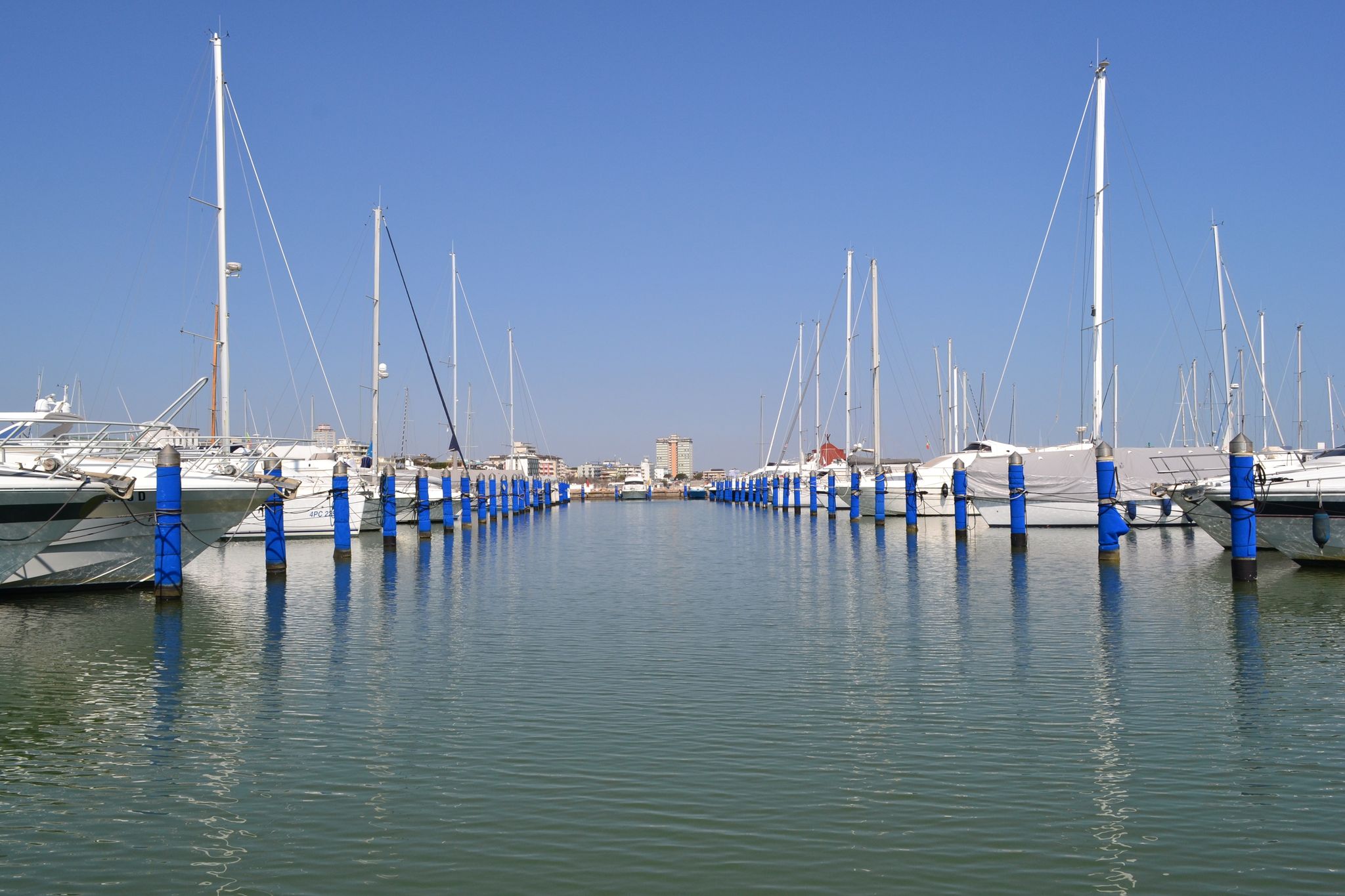 Photo of Cervia's canal, where the Salt Museum is located, with reflections on the water ,Italy.