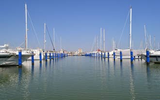 Photo of Cervia's canal, where the Salt Museum is located, with reflections on the water ,Italy.