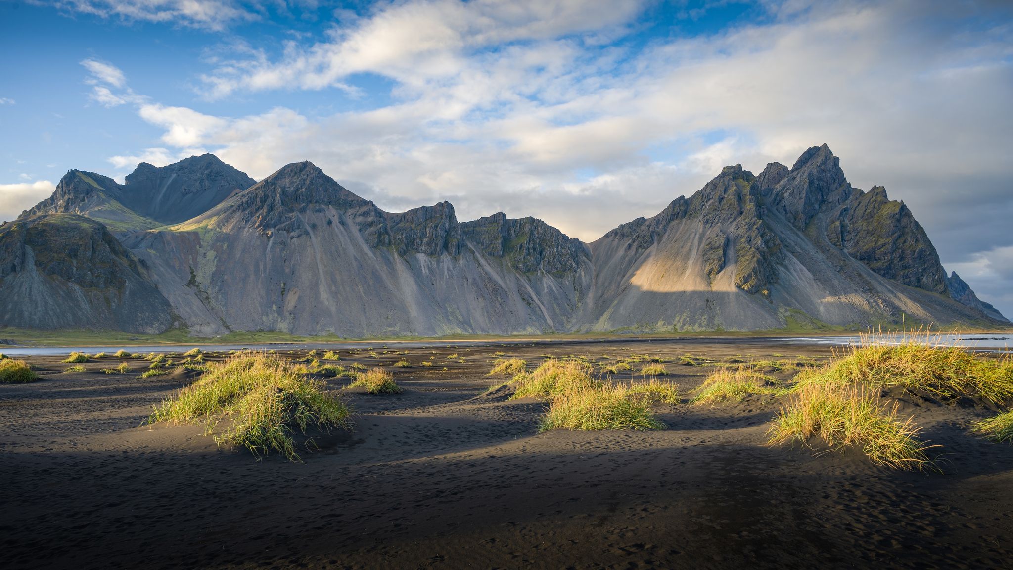 photo of view of The famous Vestrahorn range and its black sand beaches, Höfn, Iceland.
