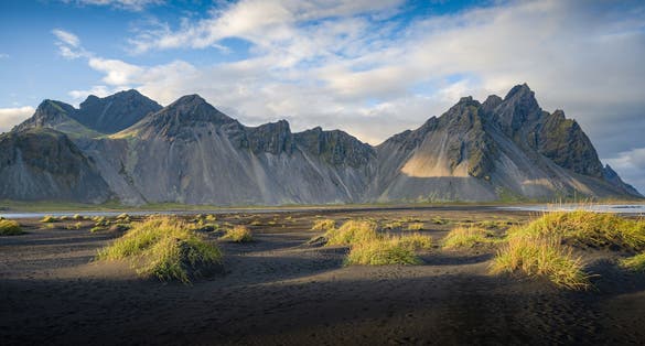 photo of view of The famous Vestrahorn range and its black sand beaches, Höfn, Iceland.