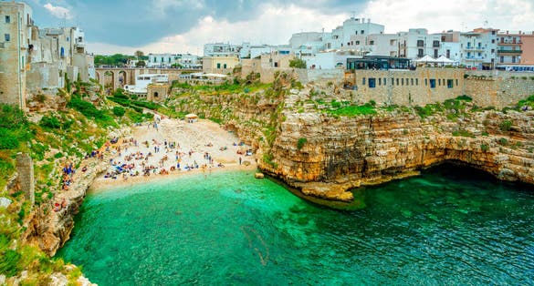 View of the beach lama Monachile Cala porto in Polignano, Puglia (Apulia), Italy. Polignano seaside of Adriatic Sea, Puglia, Italy. Polignano is a town and comune in the Metropopolitan City of Bari.