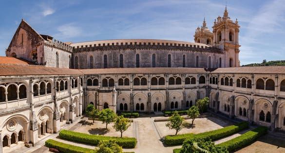 Photo of The church and the cross of the World Heritage Monastery of Saint Mary of Alcobaça, Portugal.