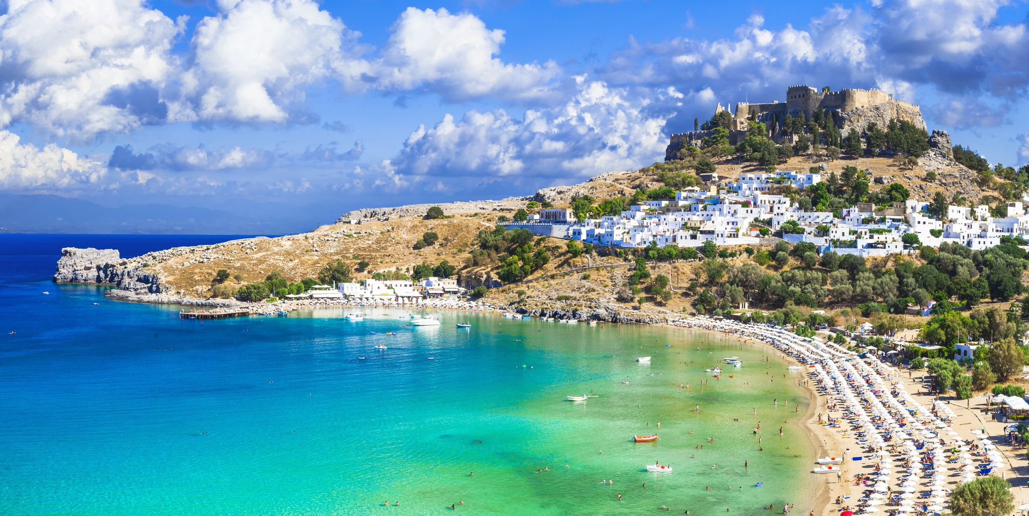 Photo of panoramic aerial view of Lindos bay, village and Acropolis, Rhodes, Greece.