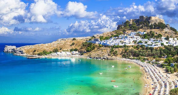Photo of panoramic aerial view of Lindos bay, village and Acropolis, Rhodes, Greece.