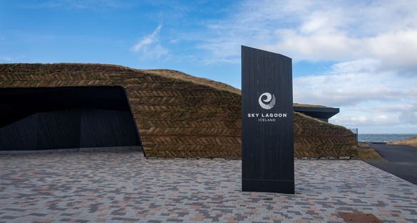 photo of Kópavogur, Iceland -2023: exterior of sky lagoon with sign and turf wall. Sky lagoon is a geothermal spa in southwestern Iceland.